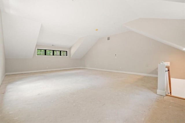 additional living space featuring lofted ceiling