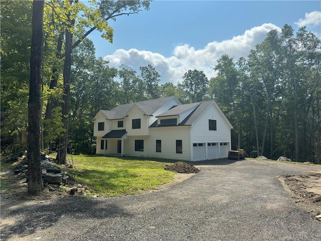 view of front of home with a garage and a front yard