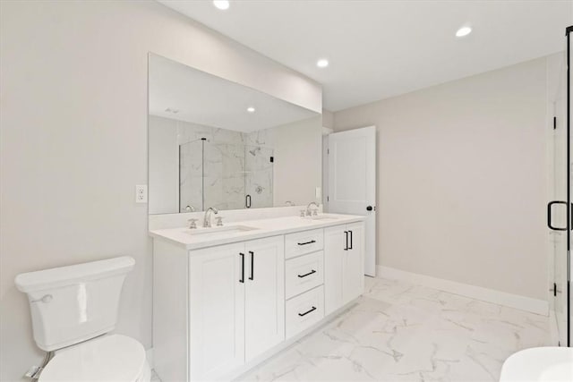 bathroom with vanity, toilet, and a shower with door