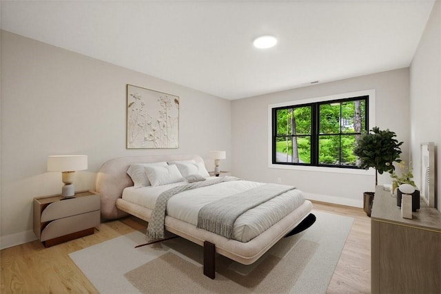 bedroom with light hardwood / wood-style flooring