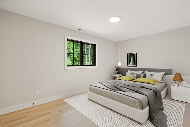 bedroom with wood-type flooring