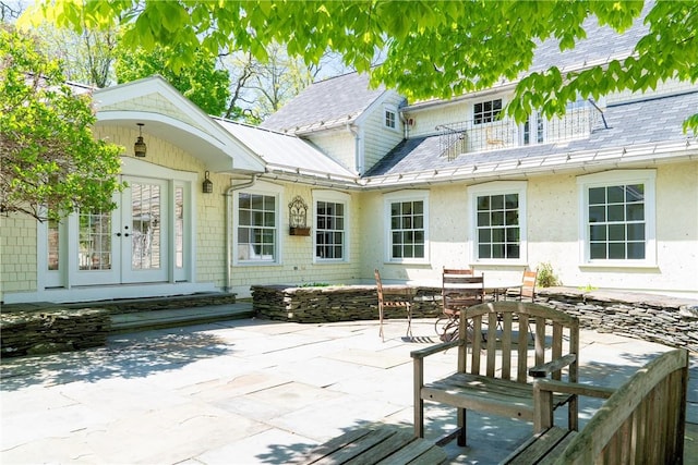 rear view of property with a patio area and french doors