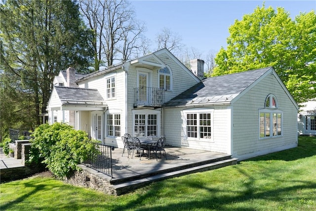 rear view of property featuring a yard