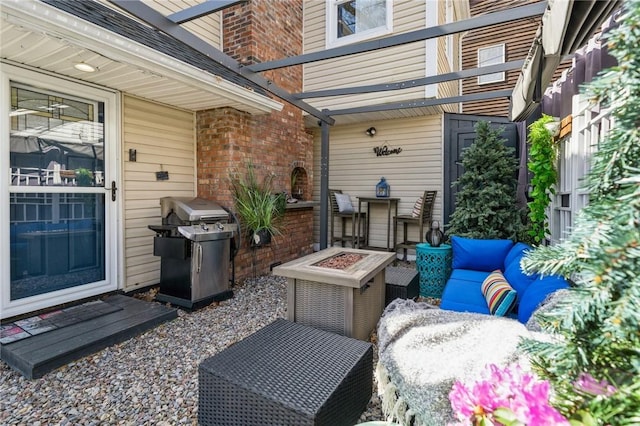 view of patio / terrace with an outdoor living space with a fire pit and a grill