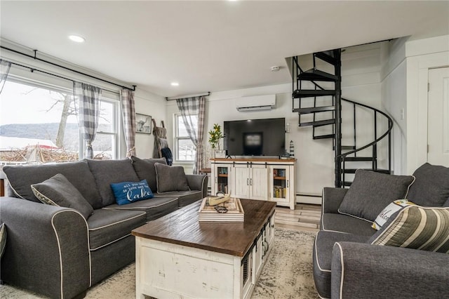 living room with a wall mounted AC, light hardwood / wood-style flooring, and a baseboard heating unit