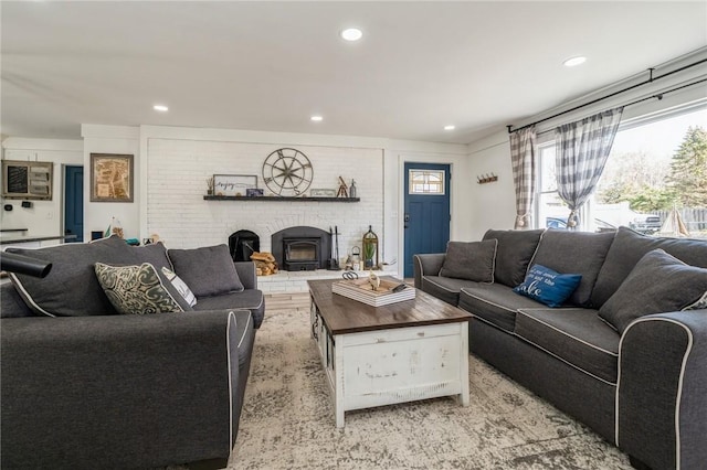 living room with light hardwood / wood-style flooring and a wood stove