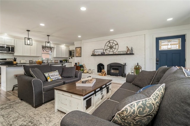 living room with light wood-type flooring and a wood stove