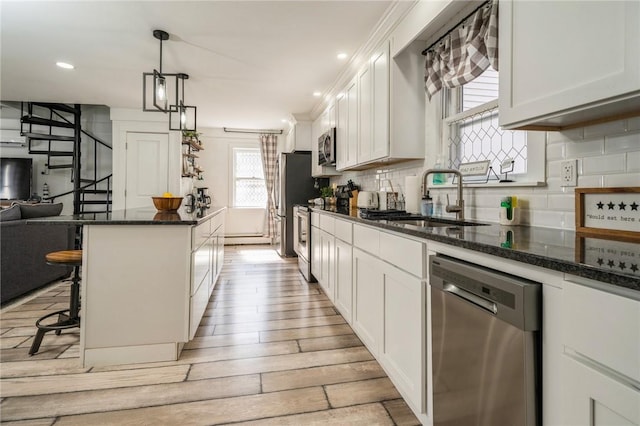 kitchen with white cabinetry, sink, and stainless steel appliances