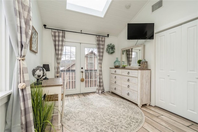 interior space with french doors, hardwood / wood-style flooring, and vaulted ceiling