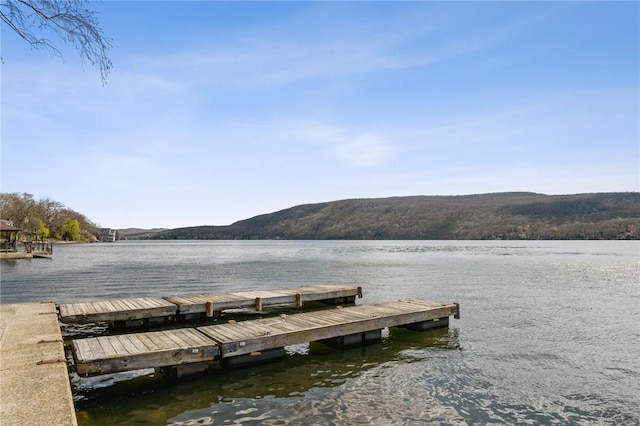 view of dock with a water and mountain view