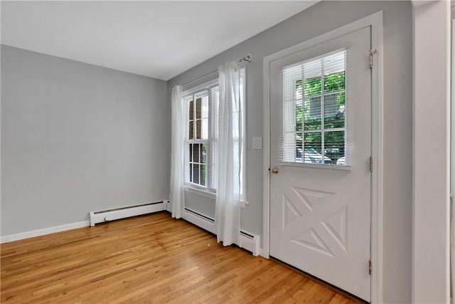 entryway featuring a baseboard radiator and light hardwood / wood-style flooring