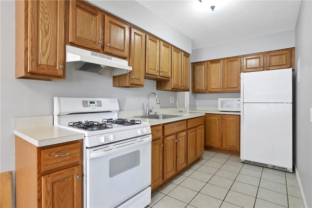 kitchen featuring sink, light tile patterned floors, and white appliances