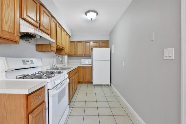 kitchen featuring white appliances, sink, and light tile patterned floors