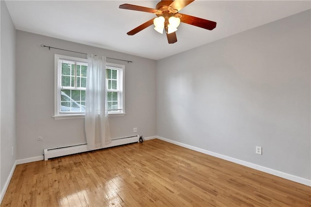 empty room featuring baseboard heating, ceiling fan, and light hardwood / wood-style floors