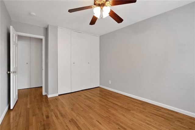 unfurnished bedroom with ceiling fan, a closet, and light hardwood / wood-style flooring