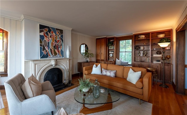 living room with crown molding and hardwood / wood-style floors