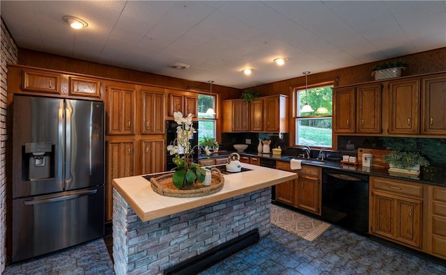 kitchen with stainless steel refrigerator with ice dispenser, a center island, dishwasher, and hanging light fixtures