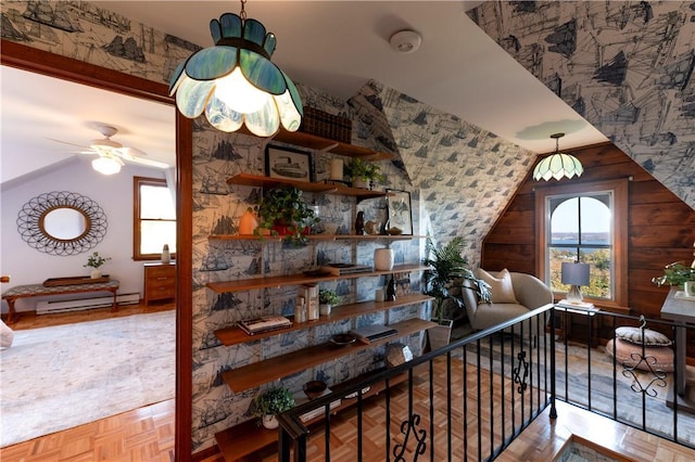 interior space featuring lofted ceiling, parquet floors, a baseboard radiator, and ceiling fan