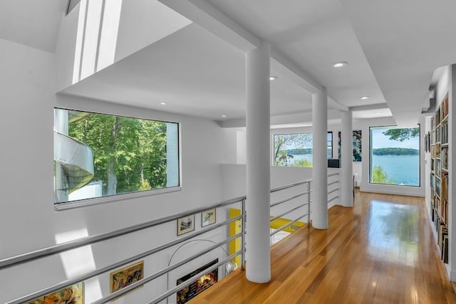 hallway featuring light wood-type flooring and a wealth of natural light