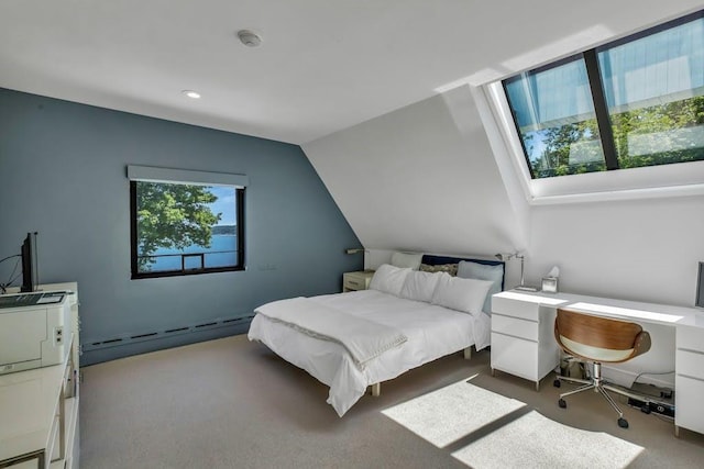 bedroom featuring dark colored carpet, vaulted ceiling, and a baseboard heating unit