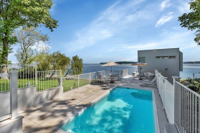 view of pool featuring a patio and a water view