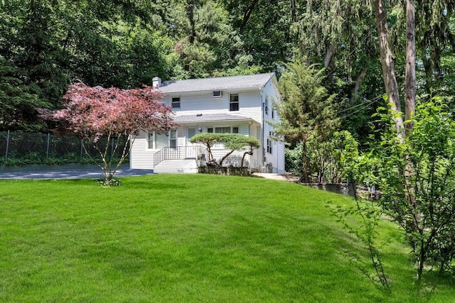 back of house featuring a yard