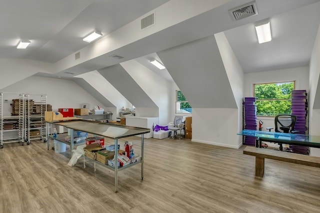 playroom with light hardwood / wood-style floors and vaulted ceiling