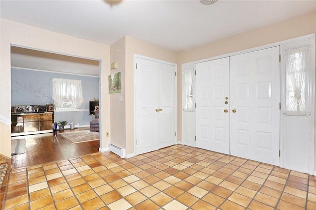 entryway with light hardwood / wood-style floors and a baseboard radiator