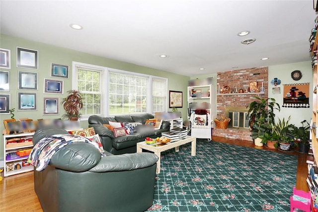 living room with a fireplace and wood-type flooring