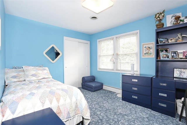 bedroom with baseboard heating and a closet