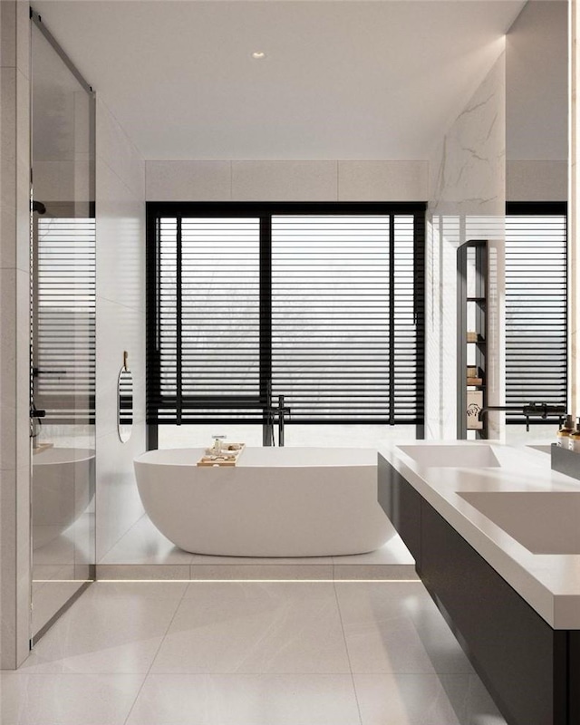 bathroom featuring tile patterned floors, vanity, and a bathing tub