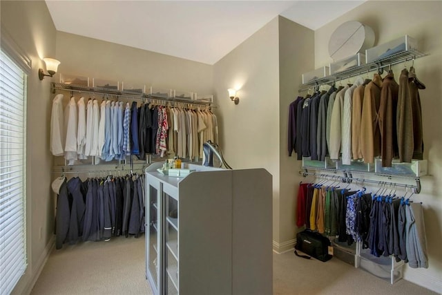 spacious closet featuring light colored carpet