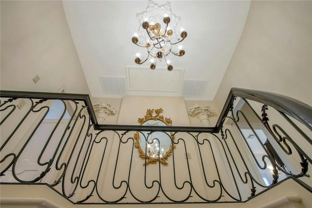 staircase featuring an inviting chandelier