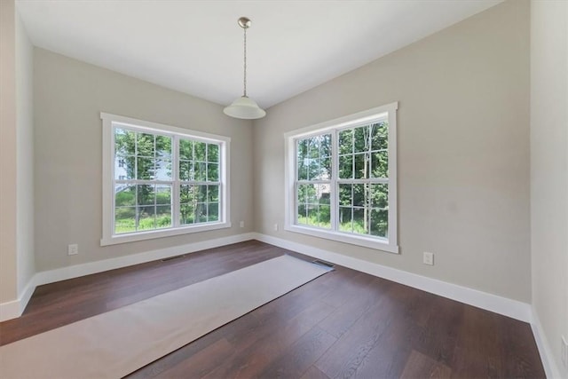 unfurnished room with dark hardwood / wood-style floors