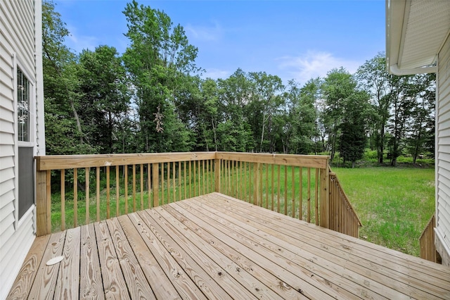 wooden terrace featuring a lawn