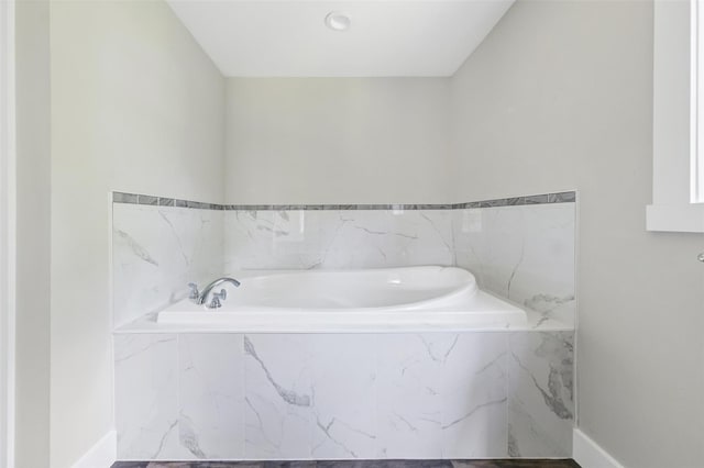 bathroom with tiled tub