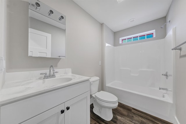 full bathroom featuring hardwood / wood-style floors, vanity, toilet, and shower / bathtub combination