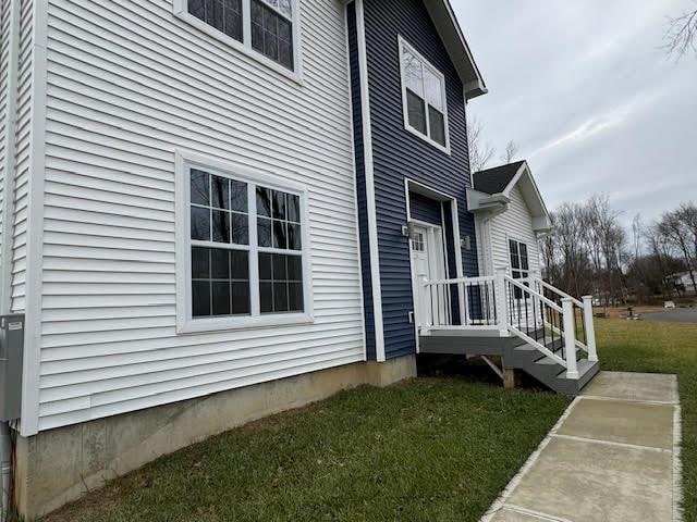 view of side of home featuring a lawn