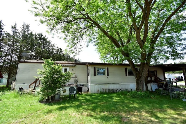 rear view of property featuring a yard