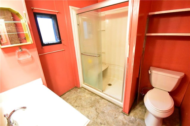 bathroom with toilet and walk in shower