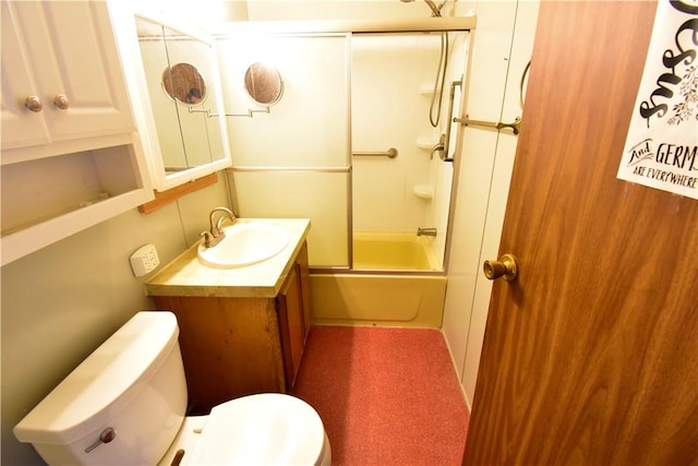 full bathroom featuring vanity, bath / shower combo with glass door, and toilet