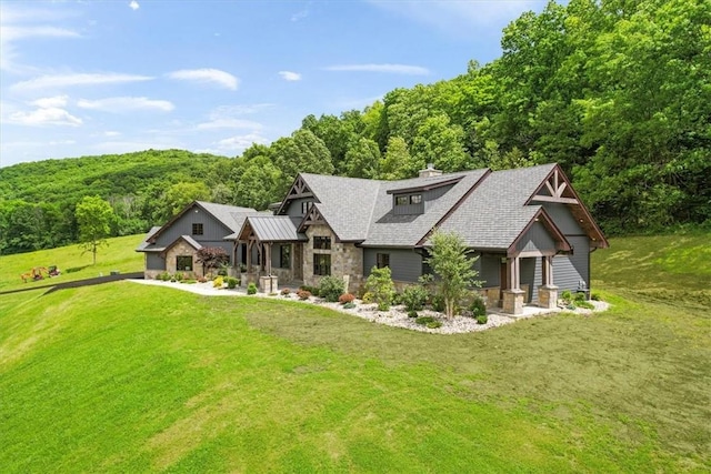 rear view of house featuring a yard