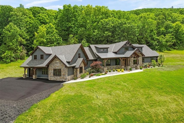 craftsman inspired home featuring covered porch and a front yard