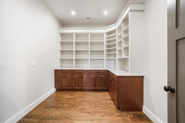 bar featuring light hardwood / wood-style flooring