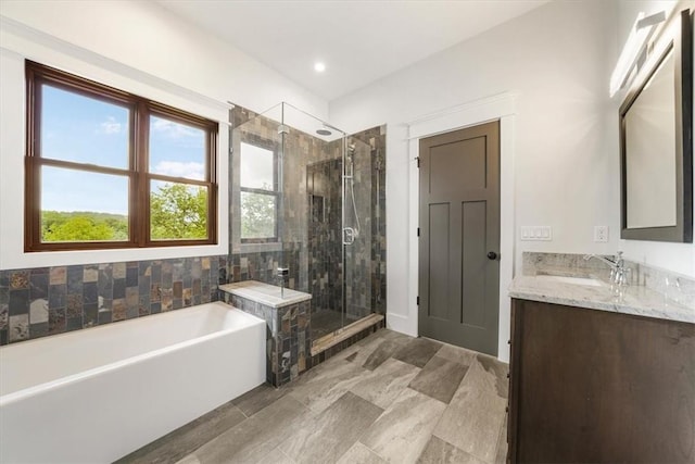 bathroom with vanity and separate shower and tub