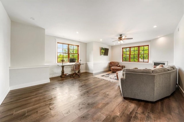 living room with ceiling fan, a healthy amount of sunlight, and dark hardwood / wood-style flooring