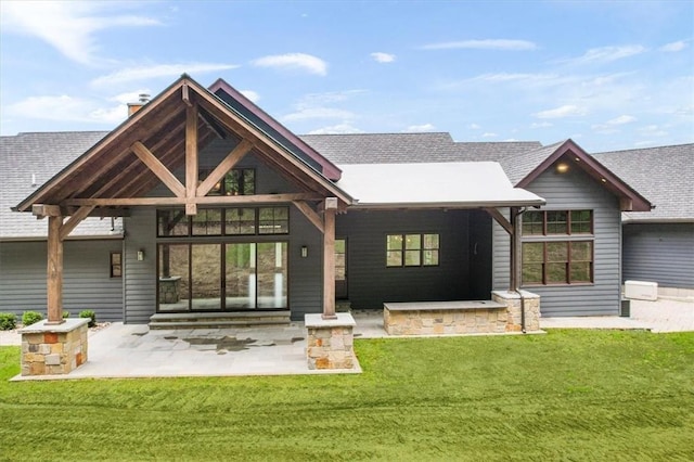 rear view of house featuring a lawn