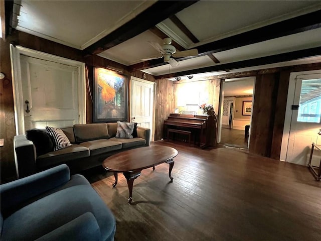 living room featuring wood walls, ceiling fan, beam ceiling, and wood-type flooring