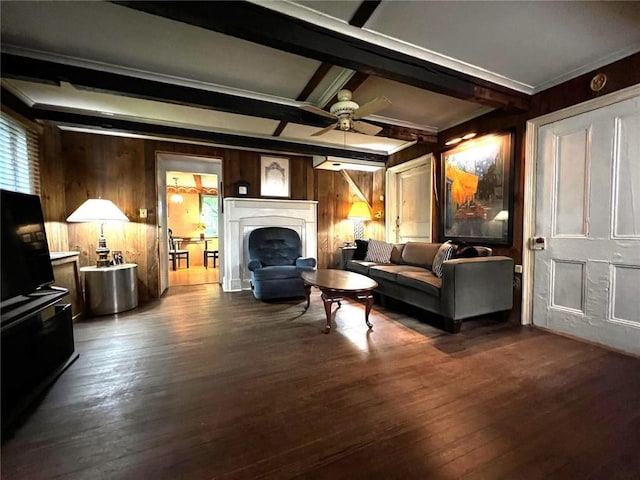 living room featuring wooden walls, dark hardwood / wood-style flooring, ceiling fan, and beamed ceiling