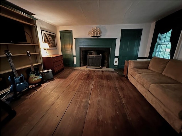 living room with hardwood / wood-style flooring and a wood stove